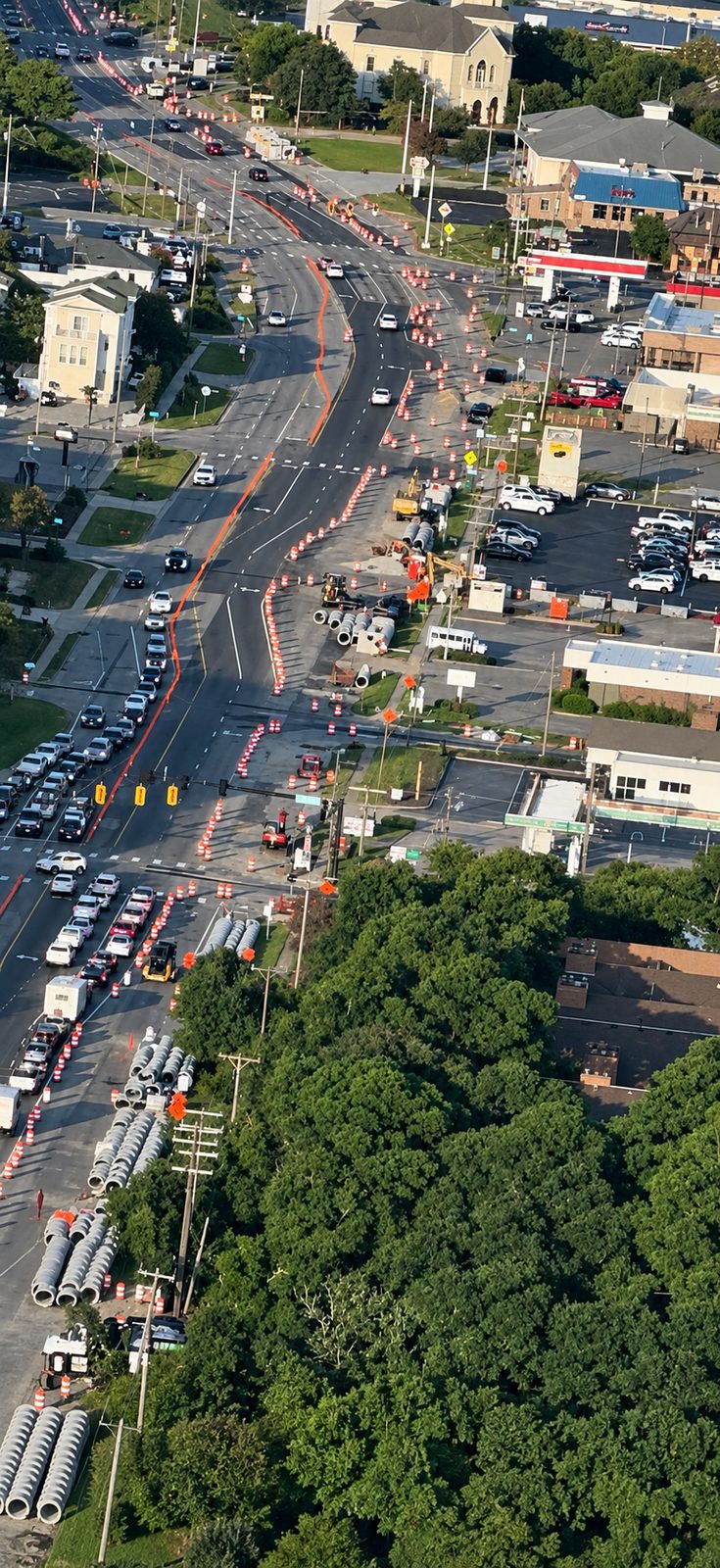 Aerial view of an active multi-lane roadway with utility relocation work underway