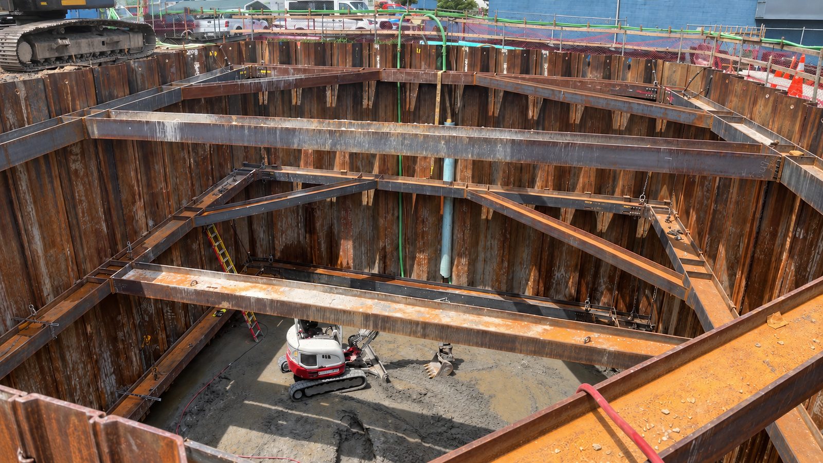 Deep utility excavation with steel sheet piling and trench shoring